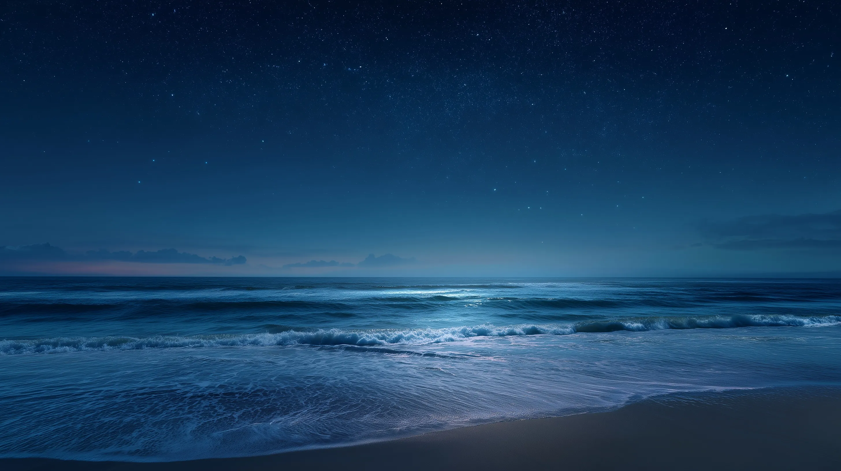 Night beach view with starry sky and mild ocean waves at dusk, serene landscape wallpaper.