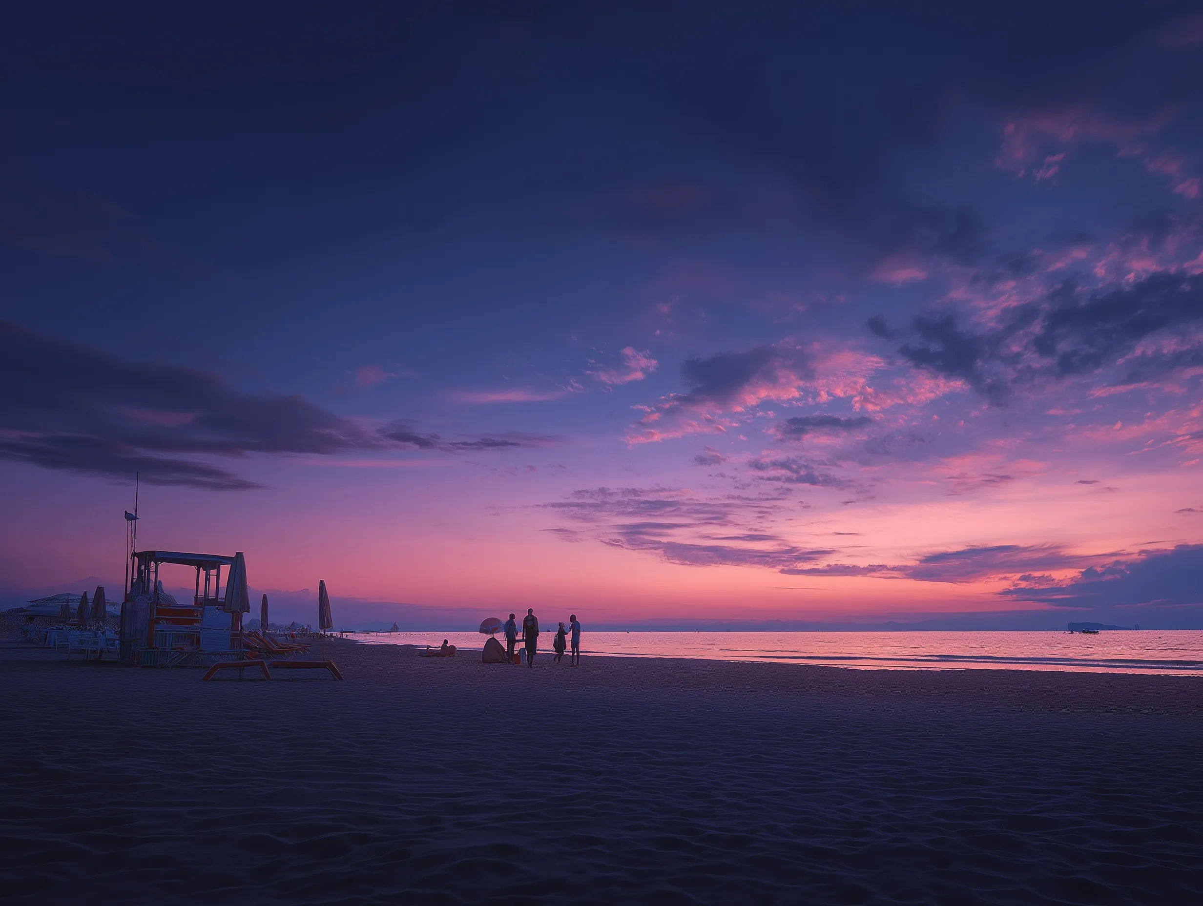 A serene beach at purple hour with a few people walking along the sandy shore during dusk.