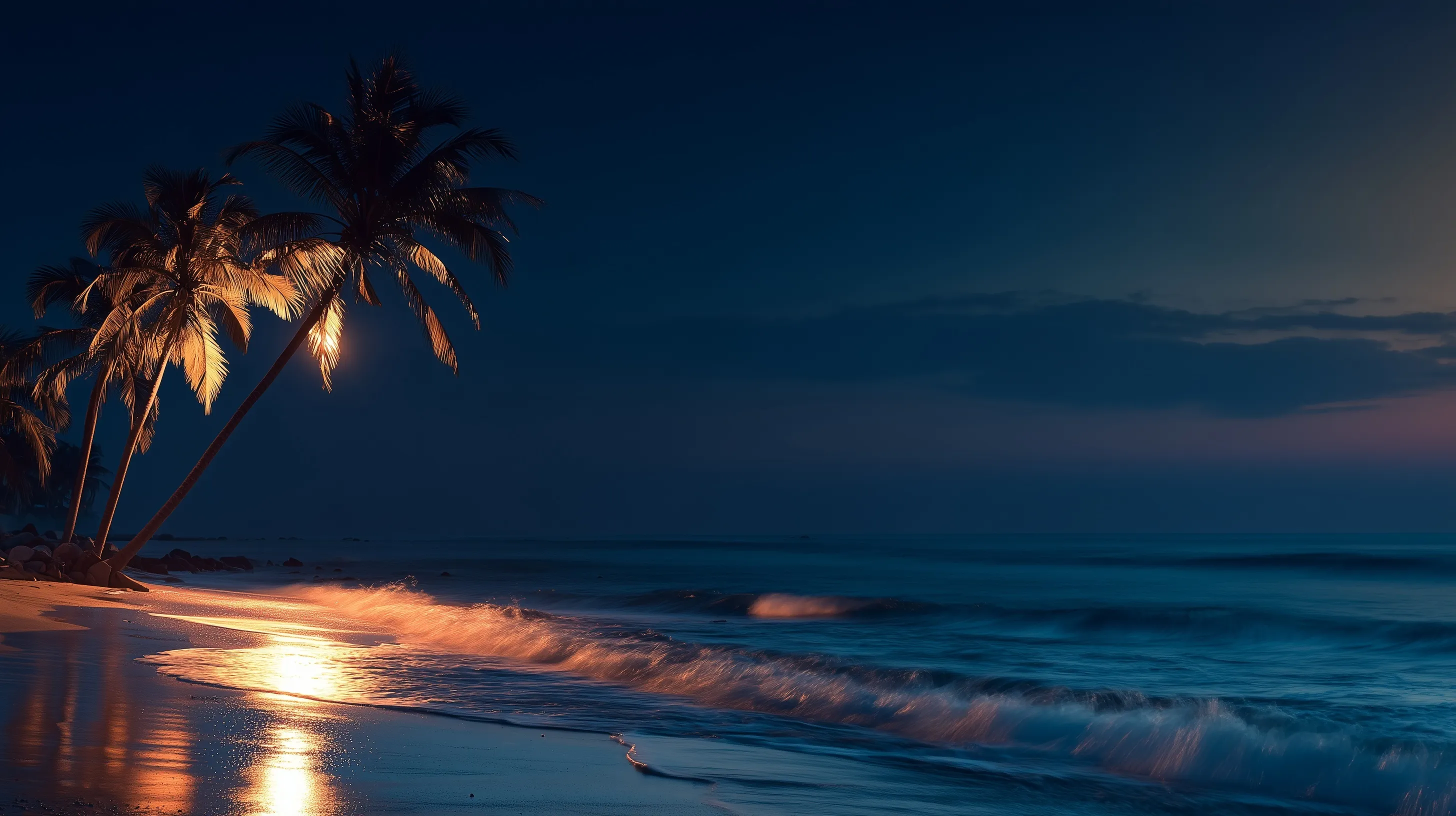 Intimate ocean waves under a deep blue twilight sky during a peaceful beach dusk.