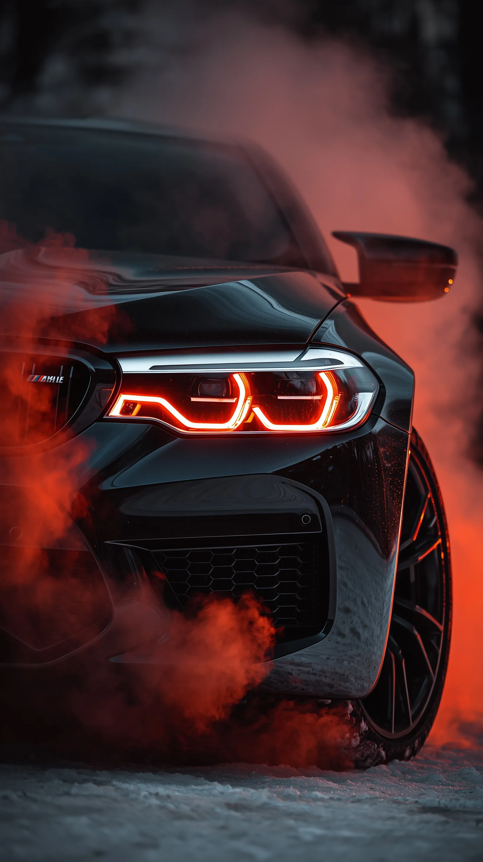 A sleek black BMW sports car with glowing red headlights and atmospheric smoke for a cinematic wallpaper.