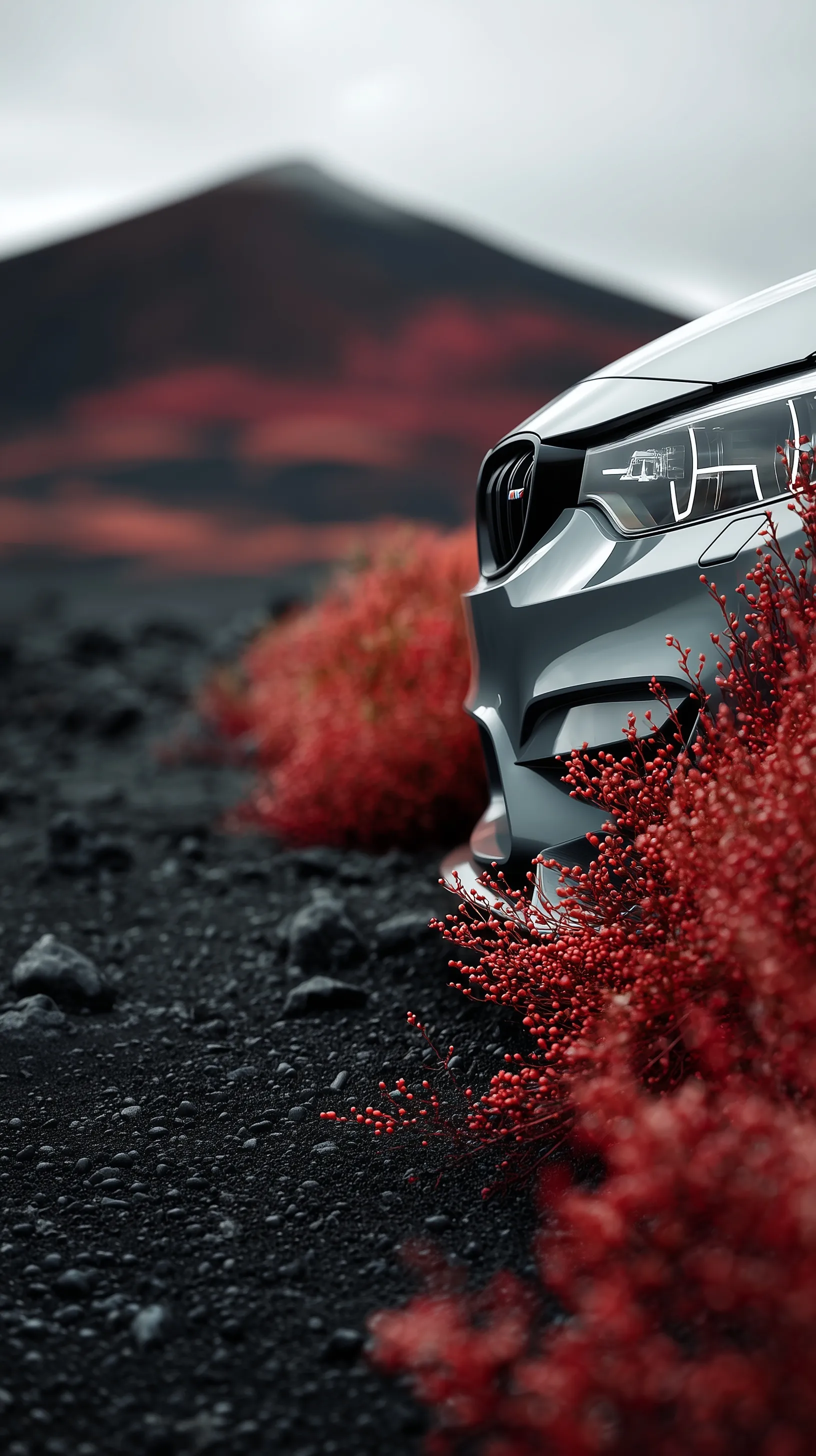 Modern BMW M3 parked on volcanic black sand with red flora, cinematic low-angle shot for iPhone wallpaper.