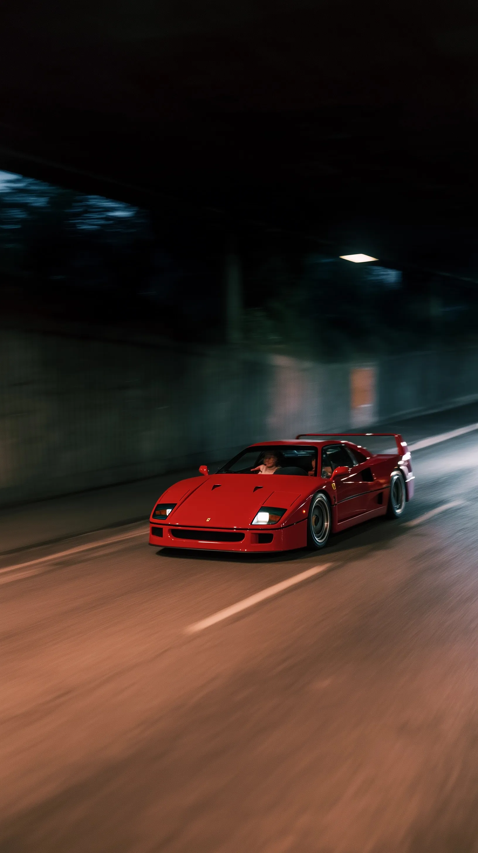 Rosso Corsa red Ferrari F40 driving fast into a dark tunnel with motion blur, perfect for iPhone wallpaper.