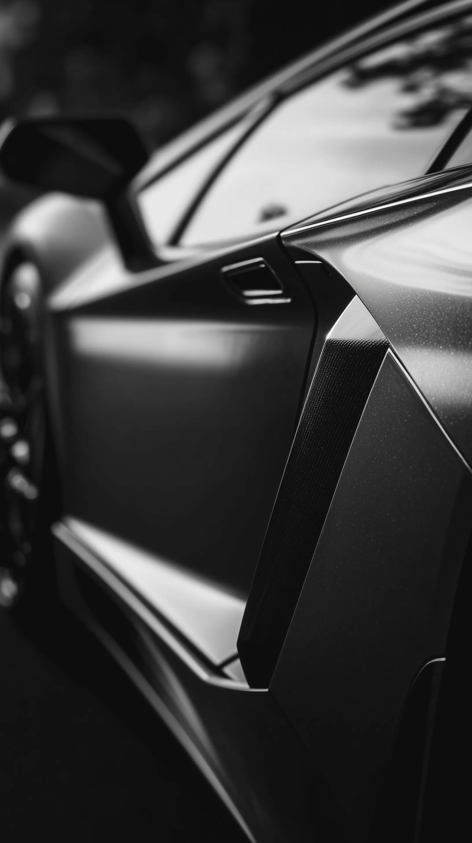 Cinematic black and white close-up of a luxury supercar door with high-contrast metallic curves and reflections.
