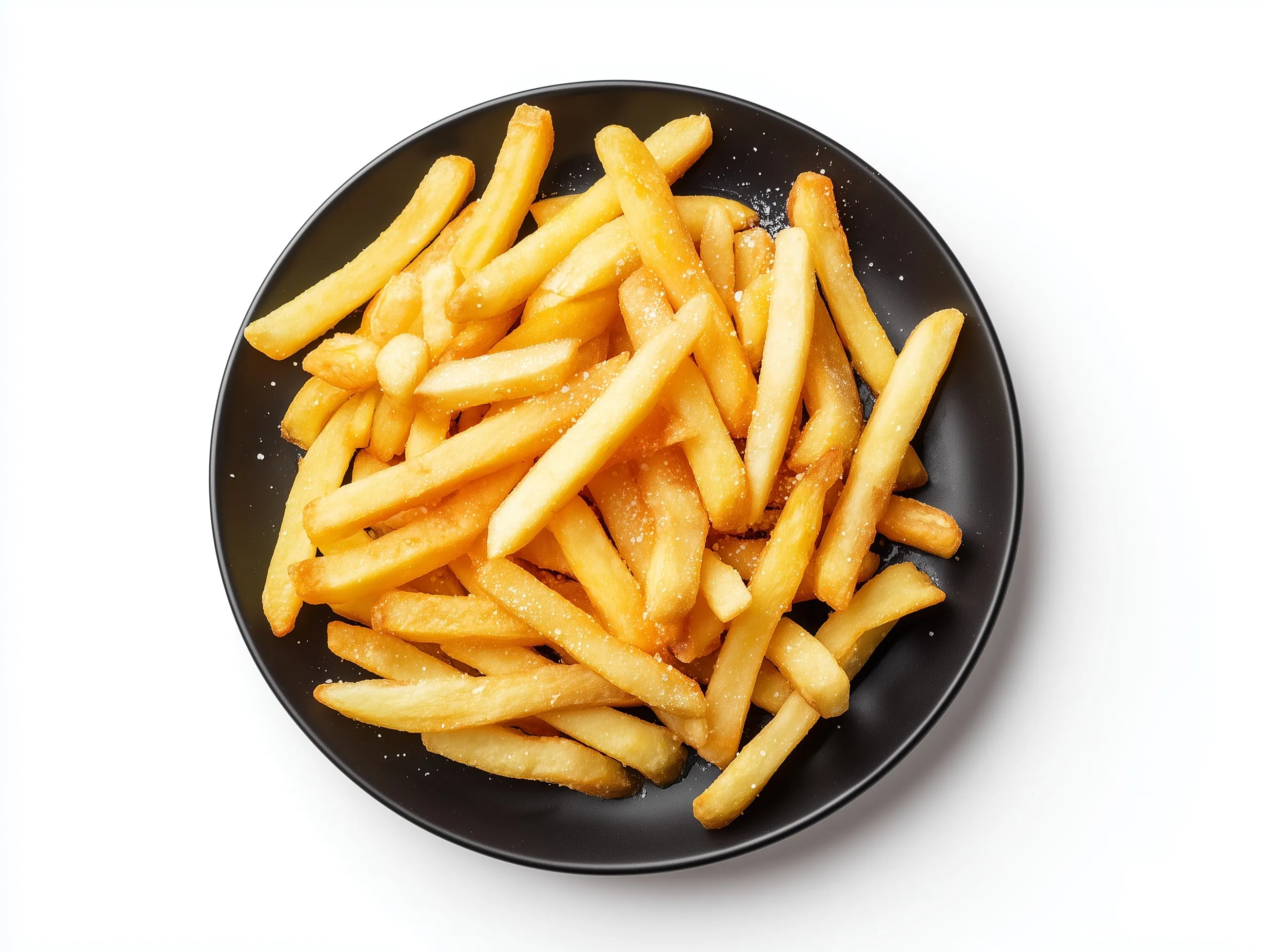 Crispy salted golden French fries served on a black ceramic plate against a clean white background, top-down view.
