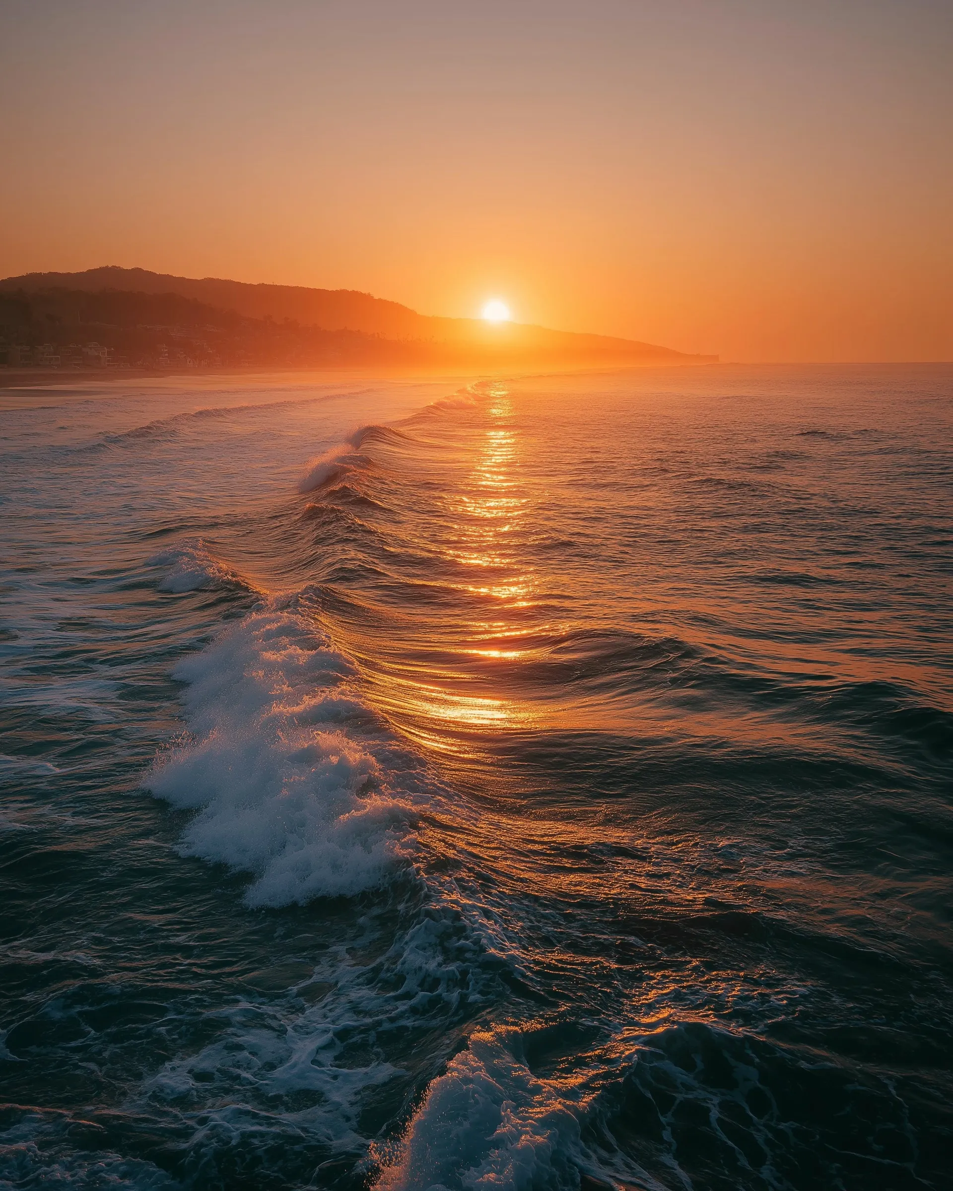 Calm ocean view at sunset with golden light reflecting on tranquil water in a dreamy California atmosphere.