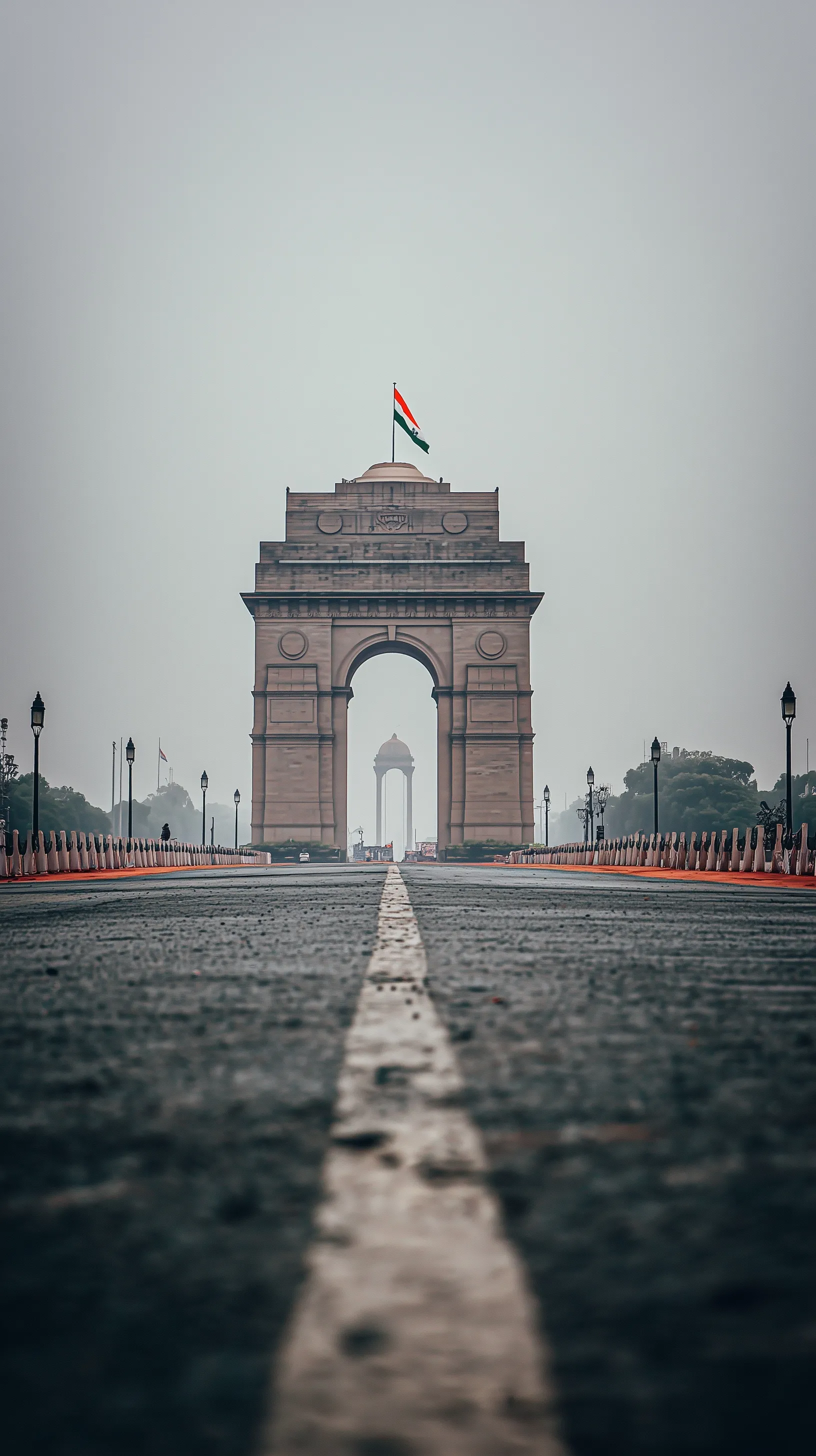 India Gate monument with a vibrant waving Indian tricolor flag against a cinematic, atmospheric background.