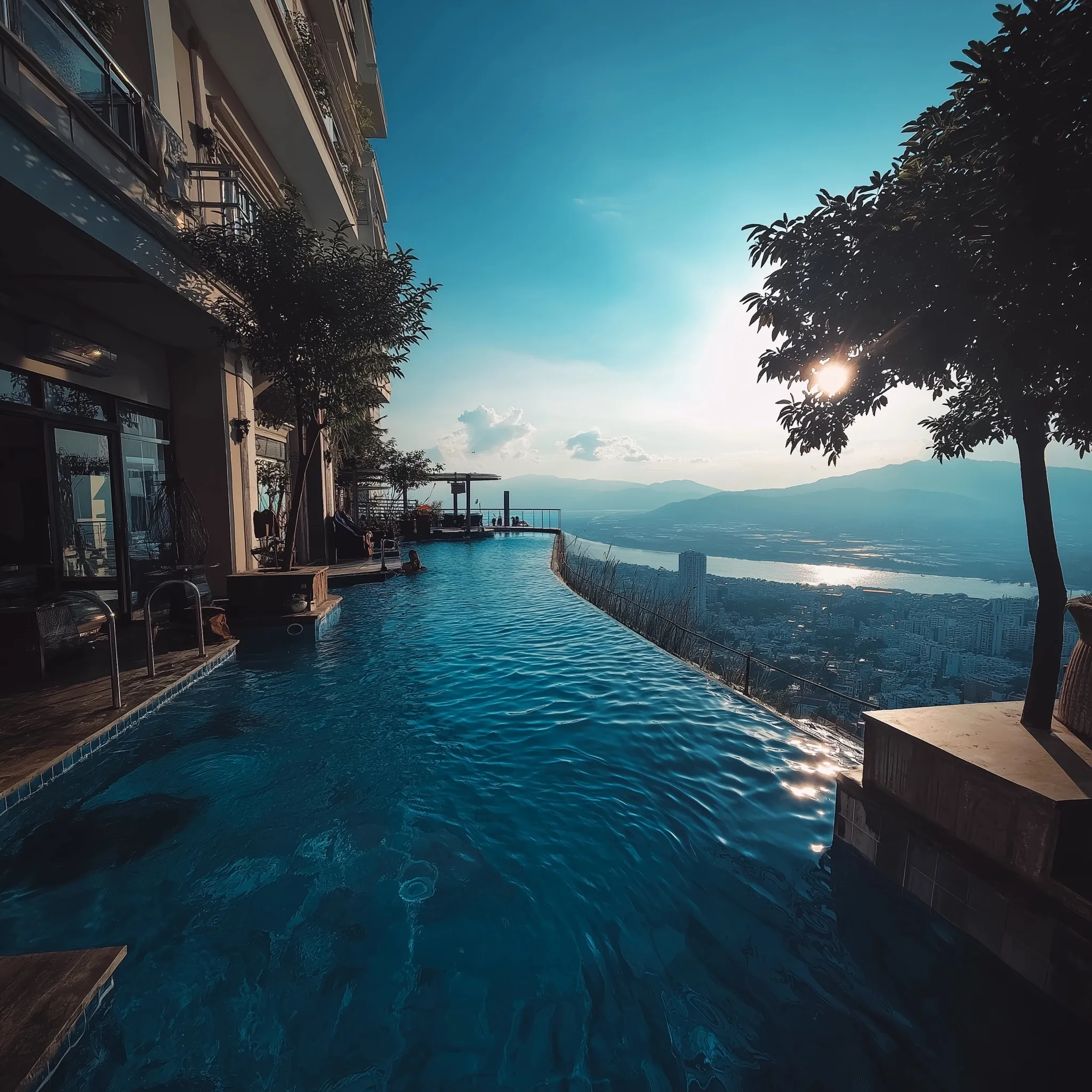 Luxury infinity pool overlooking a modern city skyline at sunset, high-end architectural design.
