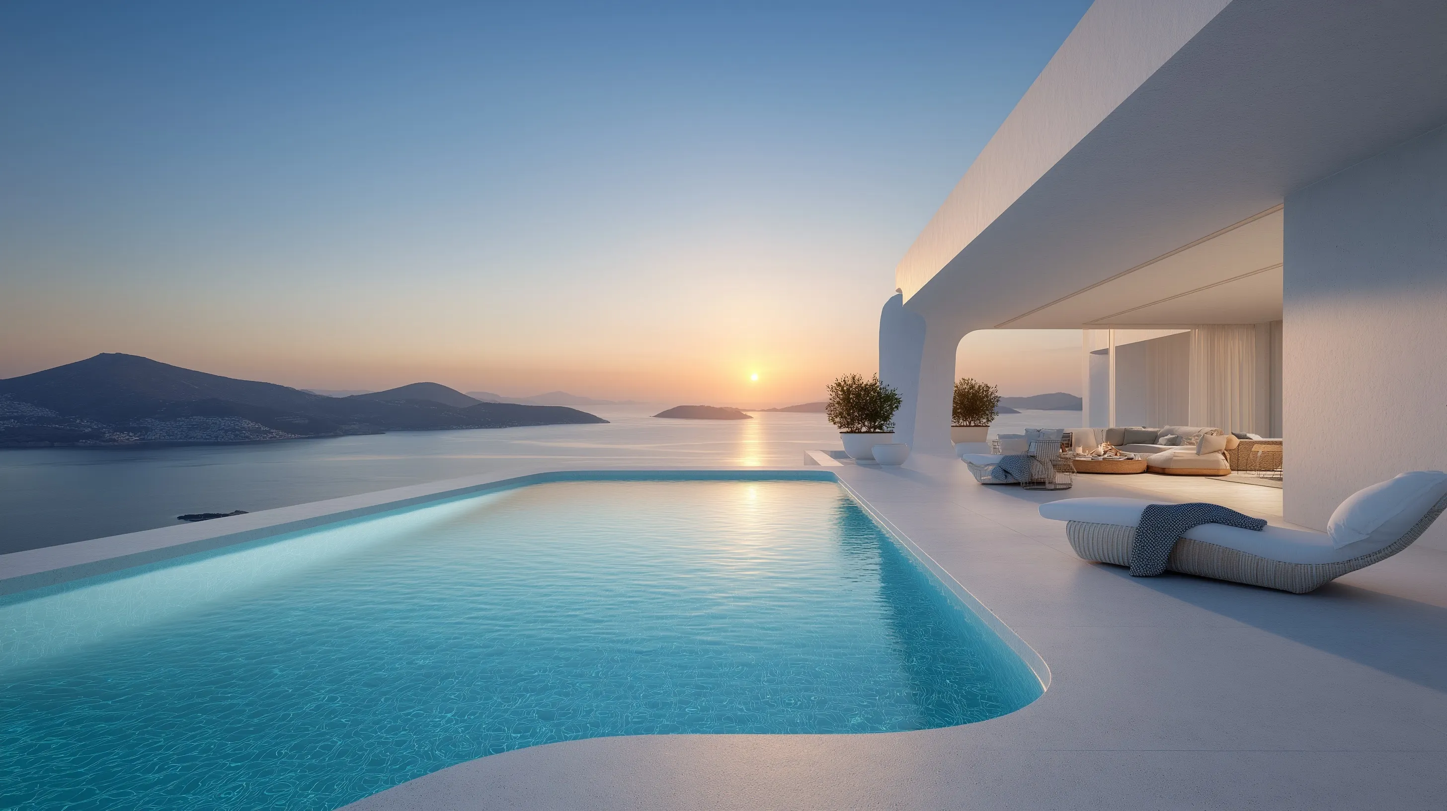 Luxury infinity pool on a modern white villa terrace overlooking a turquoise ocean during a golden hour sunset.