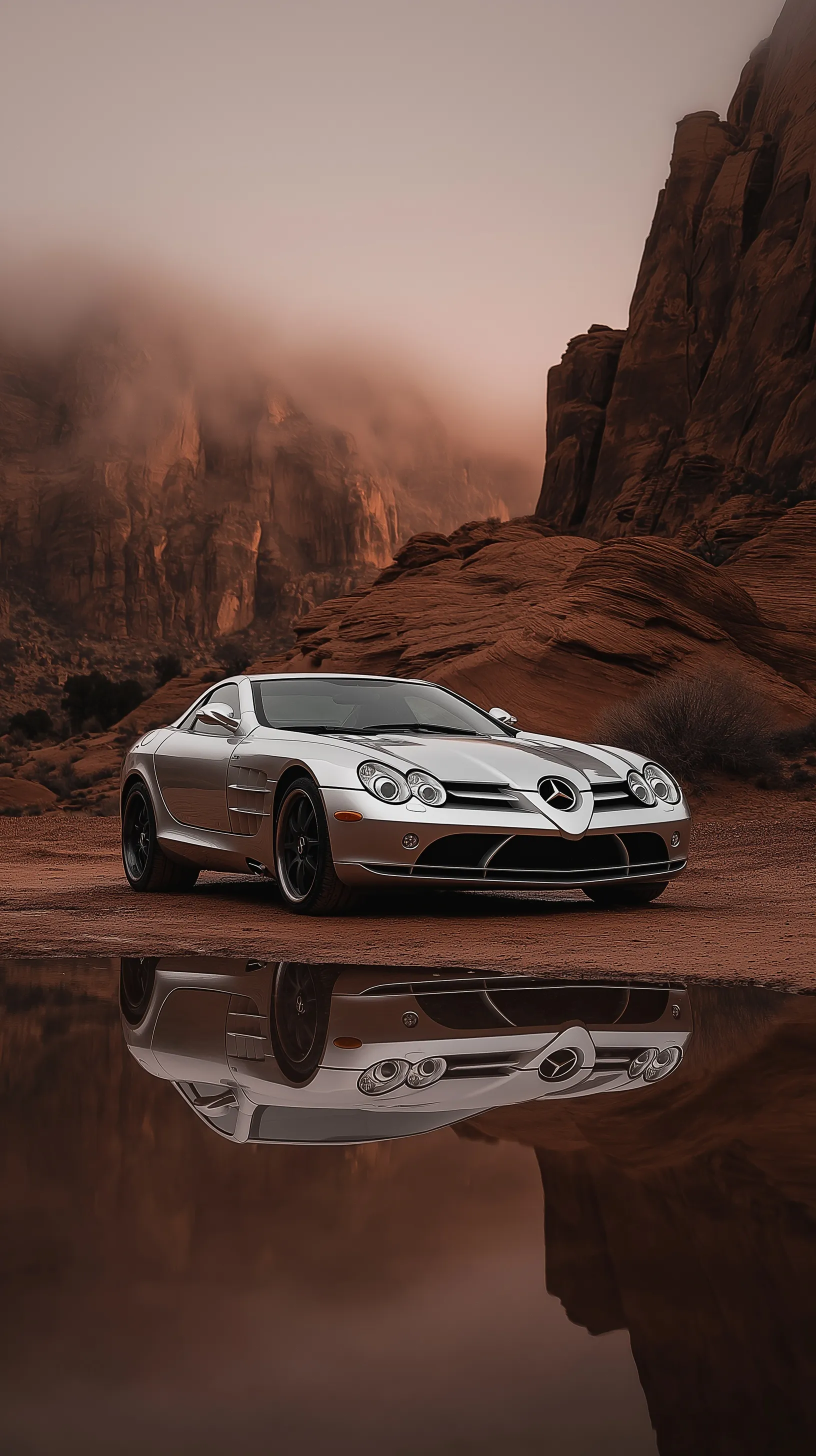 Silver Mercedes SLR McLaren parked by water in a foggy Red Rock Canyon at sunset, cinematic desert wallpaper.