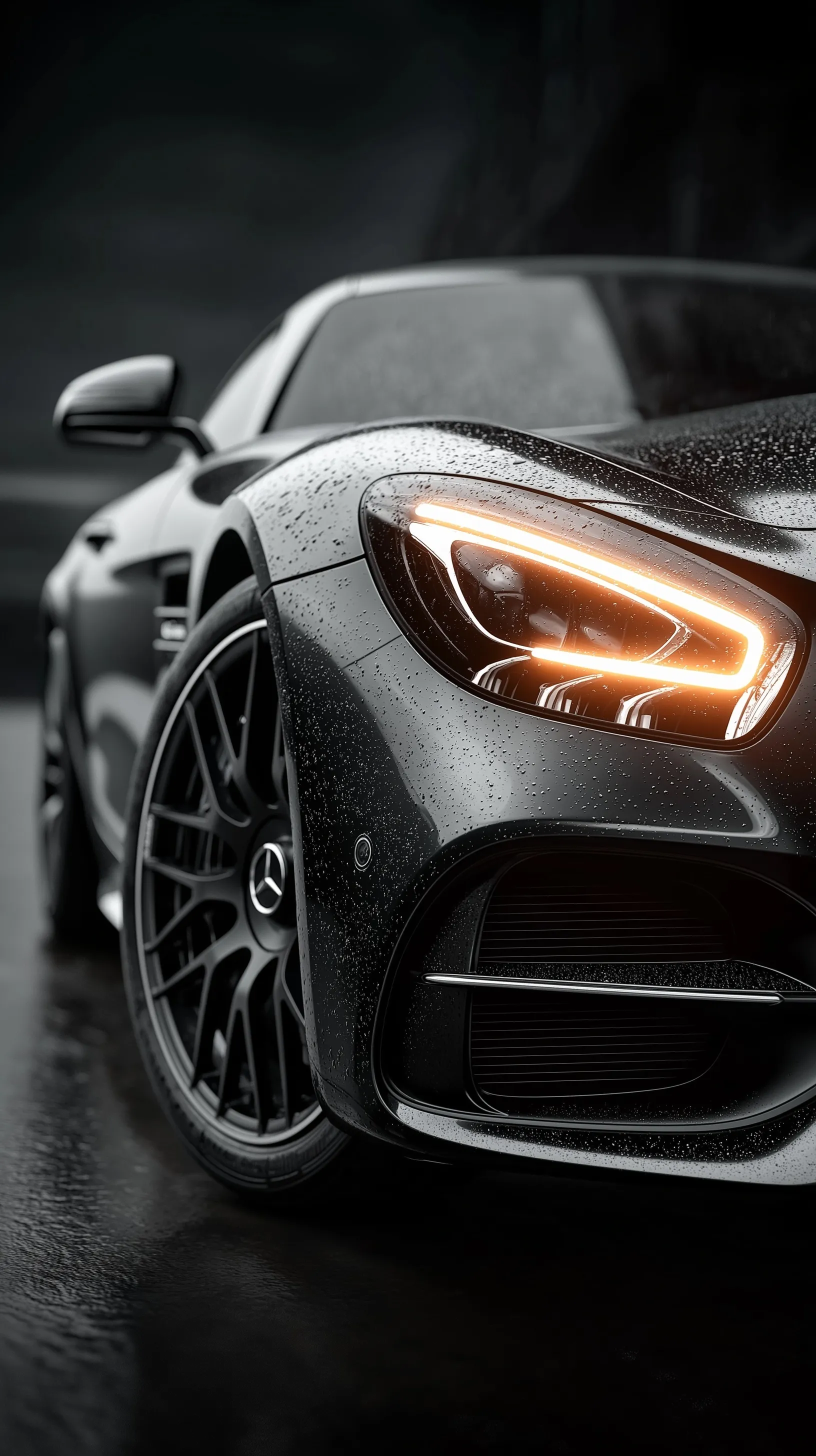 Close-up of a glowing Mercedes-AMG GT LED headlight on a black car with rain droplets, cinematic night photography.