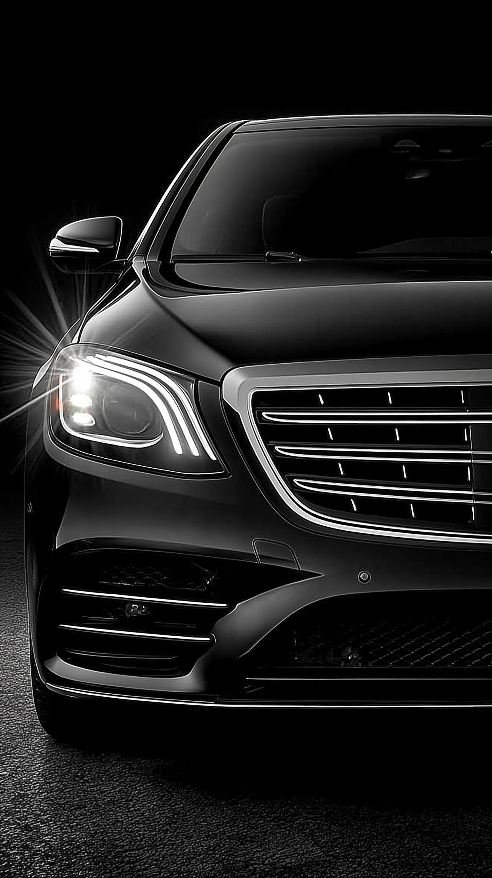 Front view of a black Mercedes-Benz V 300 extralong luxury van isolated on a professional black background.