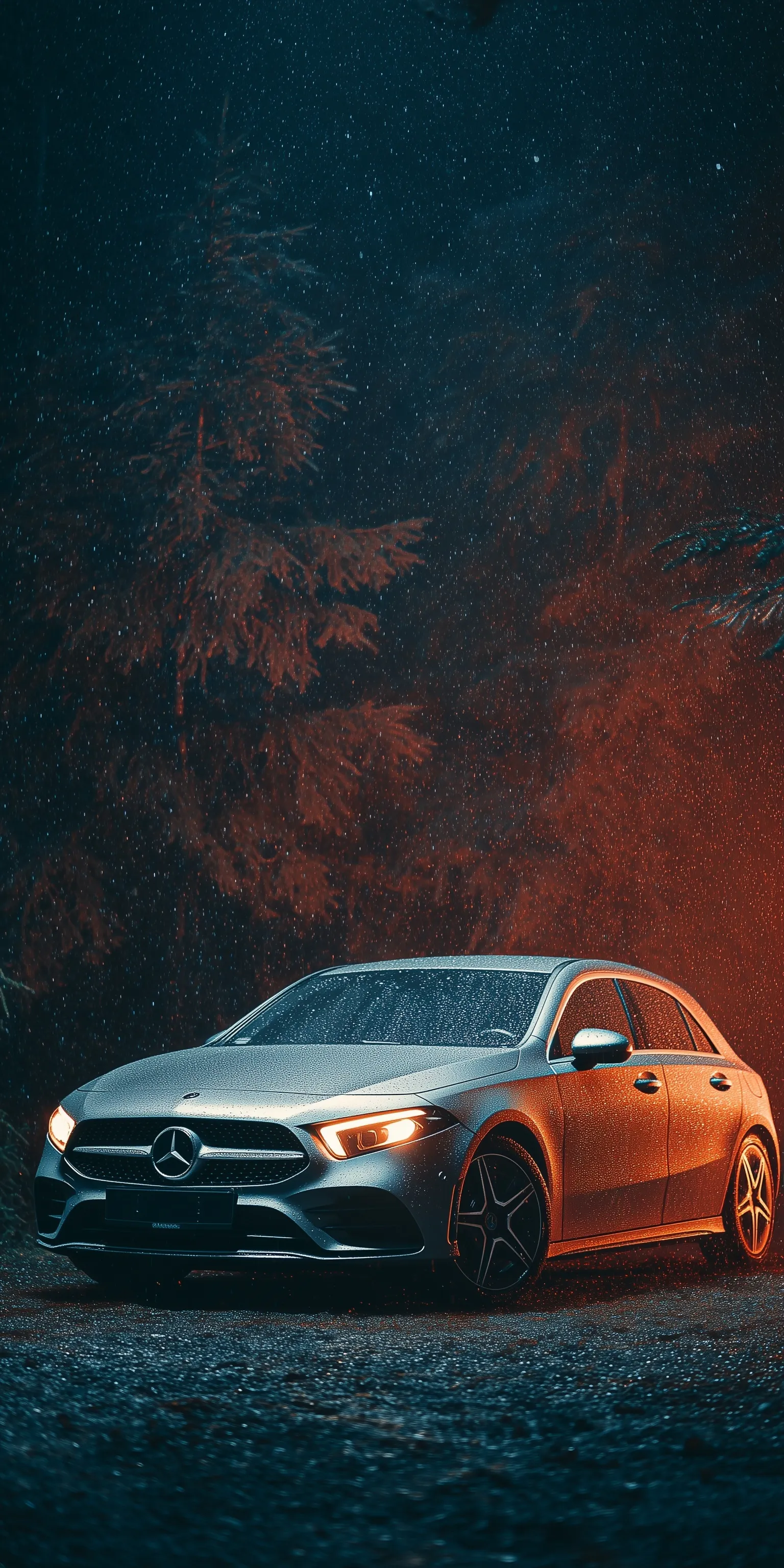 A sleek Mercedes A200 with water droplets parked in a dark forest at night, captured in high-resolution photography.