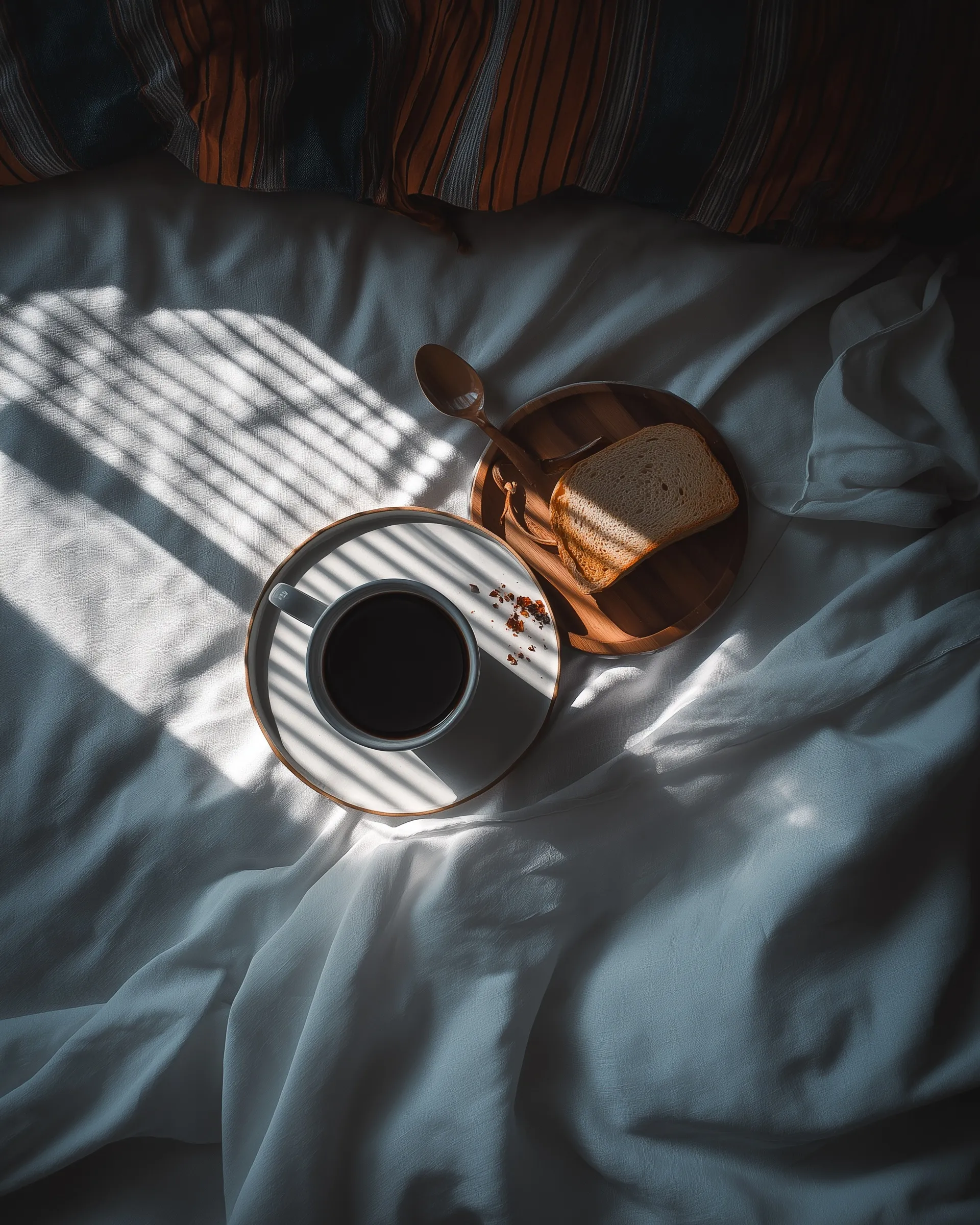 A cozy morning flat lay featuring a steaming cup of coffee on a rustic wooden table with soft aesthetic lighting.