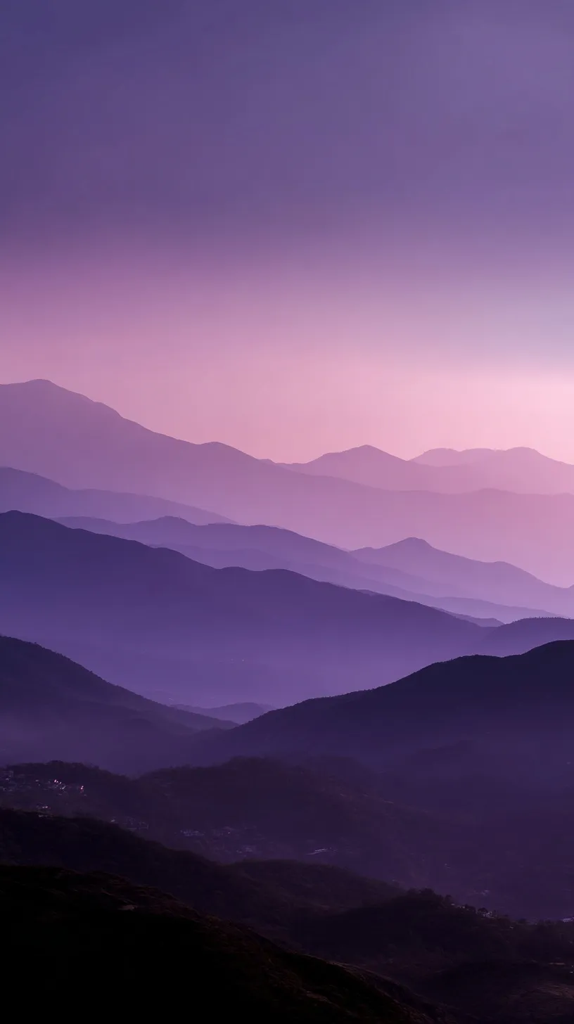 Layered mountain silhouettes against a misty violet twilight sky for iPhone 17 Pro Max wallpaper.