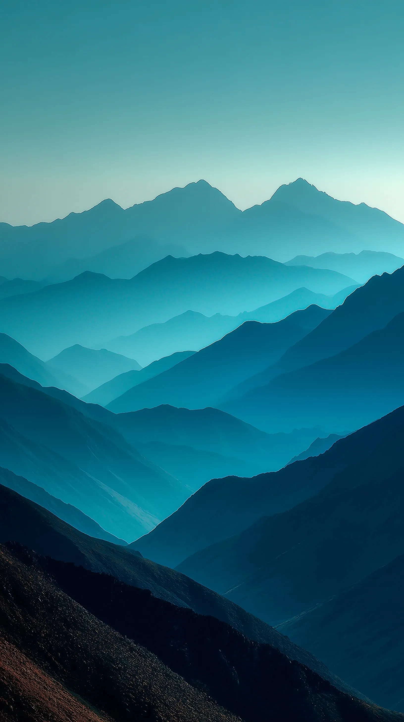 Minimalist layered mountain landscape wallpaper in teal-blue with soft fog for iPhone 17 Pro Max.
