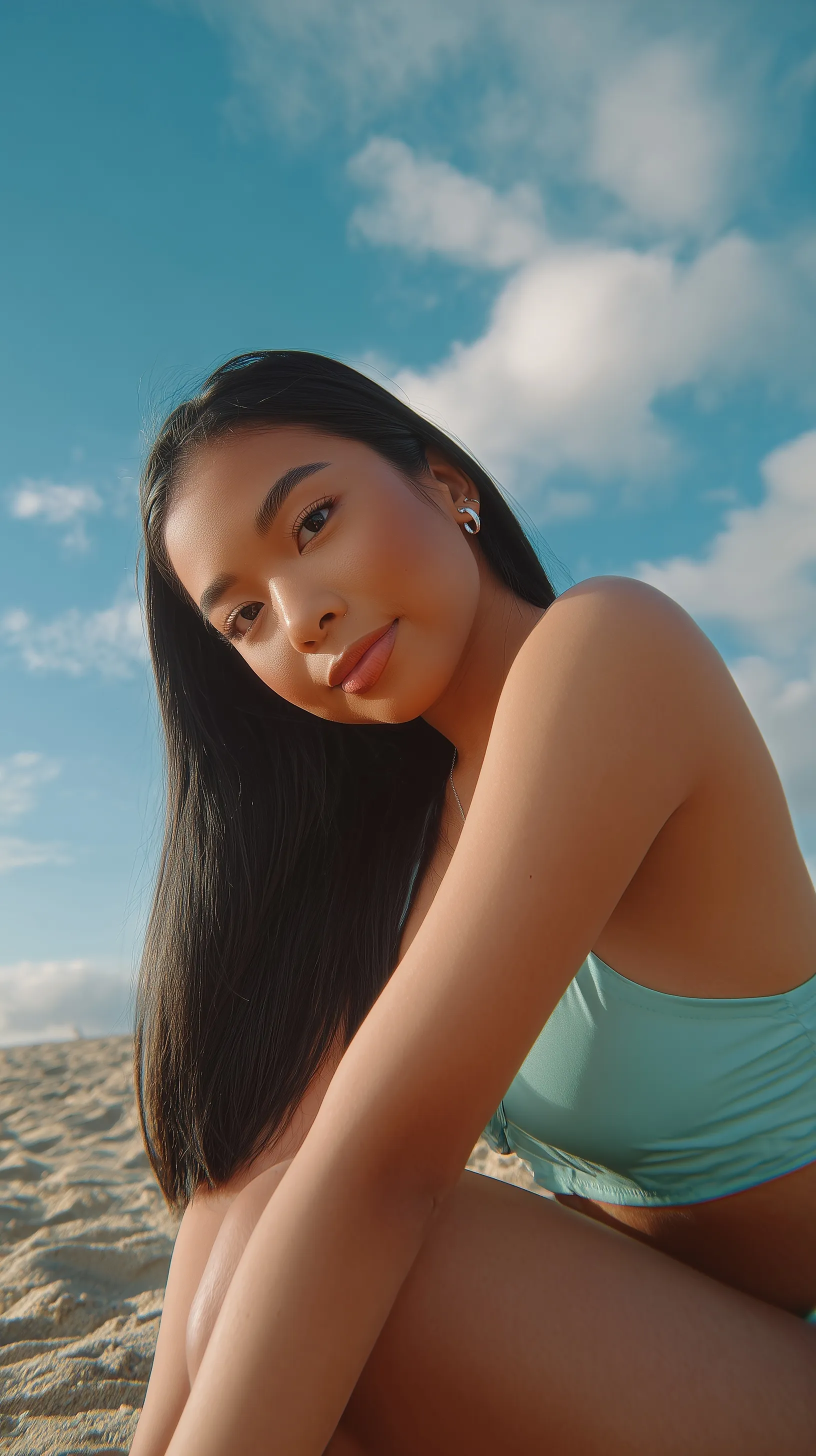 A beautiful 21-year-old Filipina woman in a swim set posing on a sunny beach during golden hour.