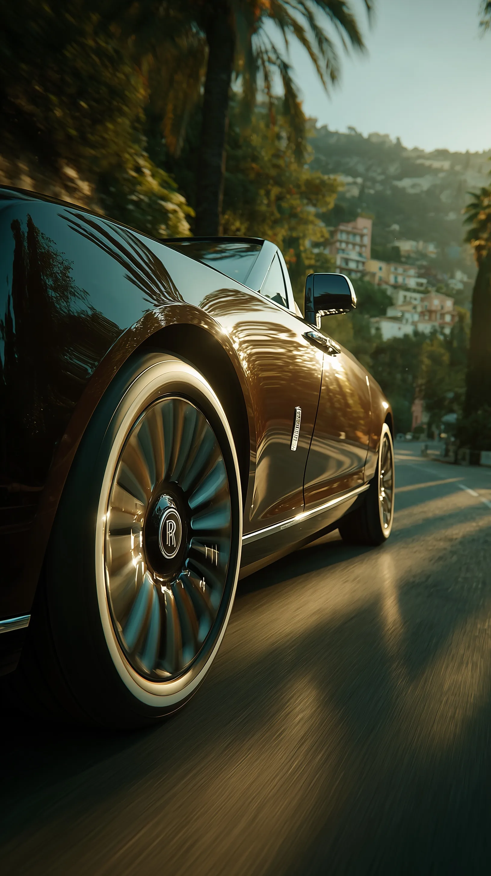Close-up of a Rolls-Royce Boat Tail wheel rolling on a scenic Spanish mountain road during golden hour.