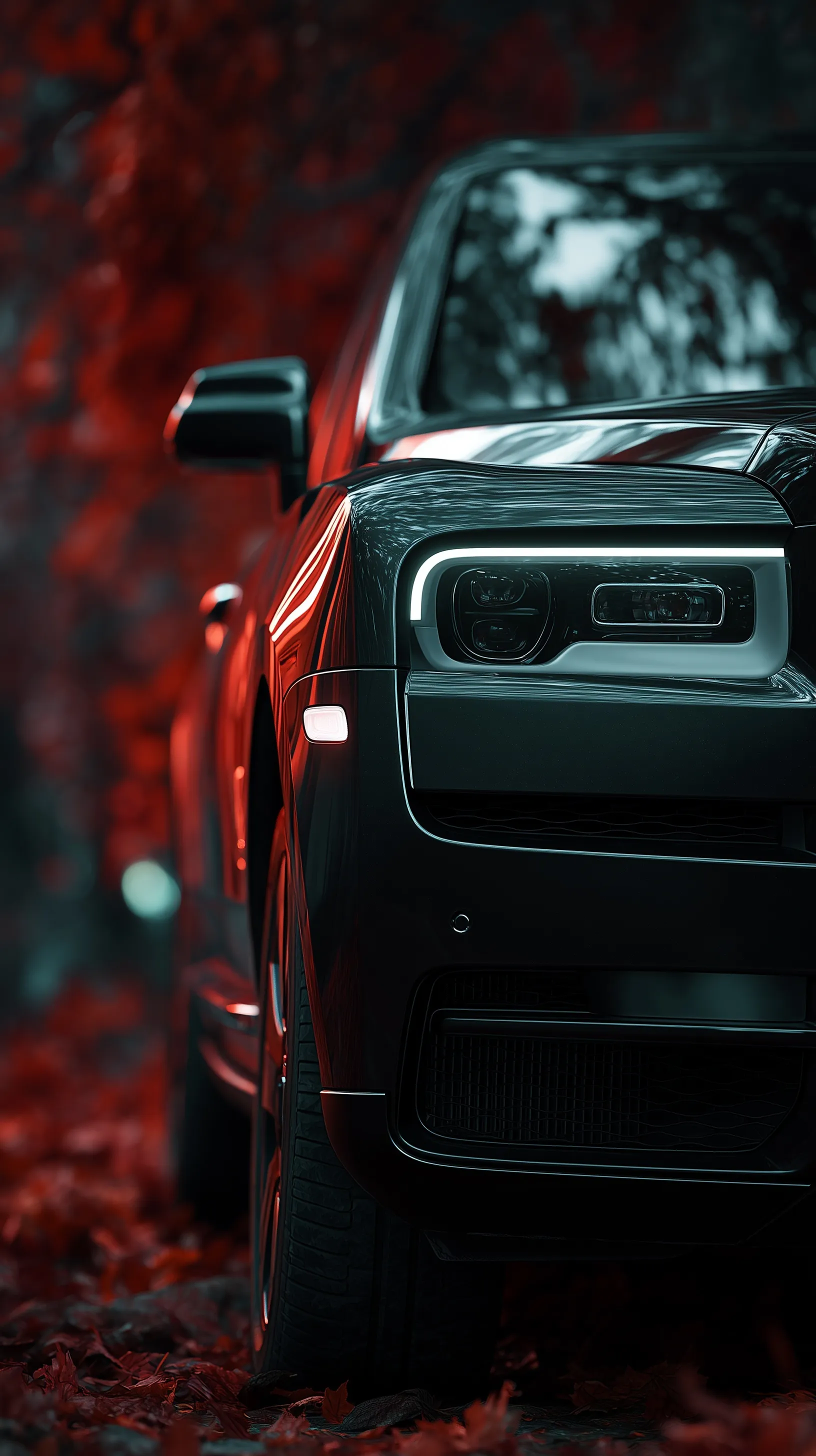 Close-up of a black Rolls-Royce Cullinan on red autumn leaves with cinematic dark moody lighting and bokeh.