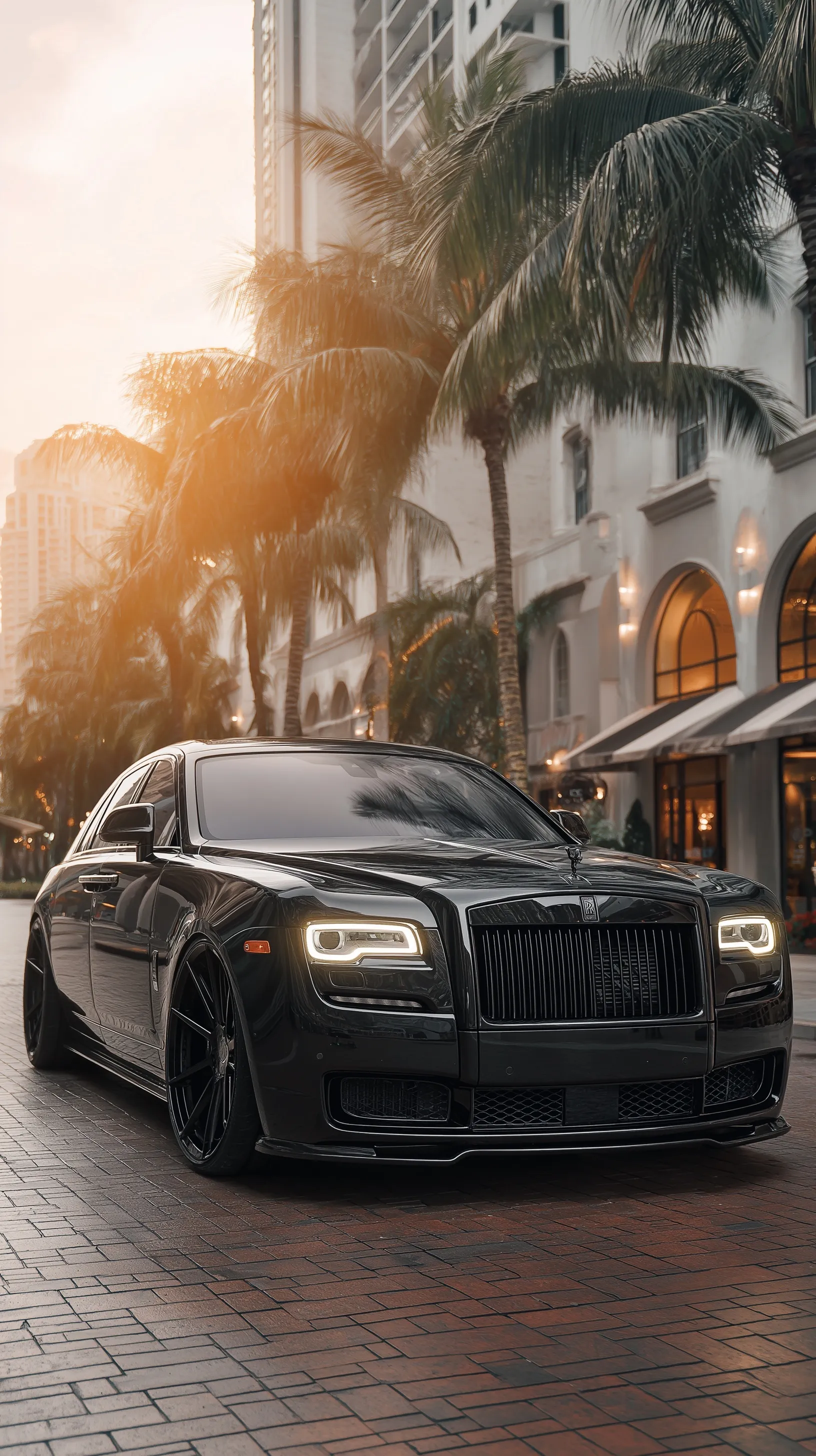 Professional photo of a luxury Rolls-Royce parked on a vibrant Miami street, perfect for iPhone wallpaper.
