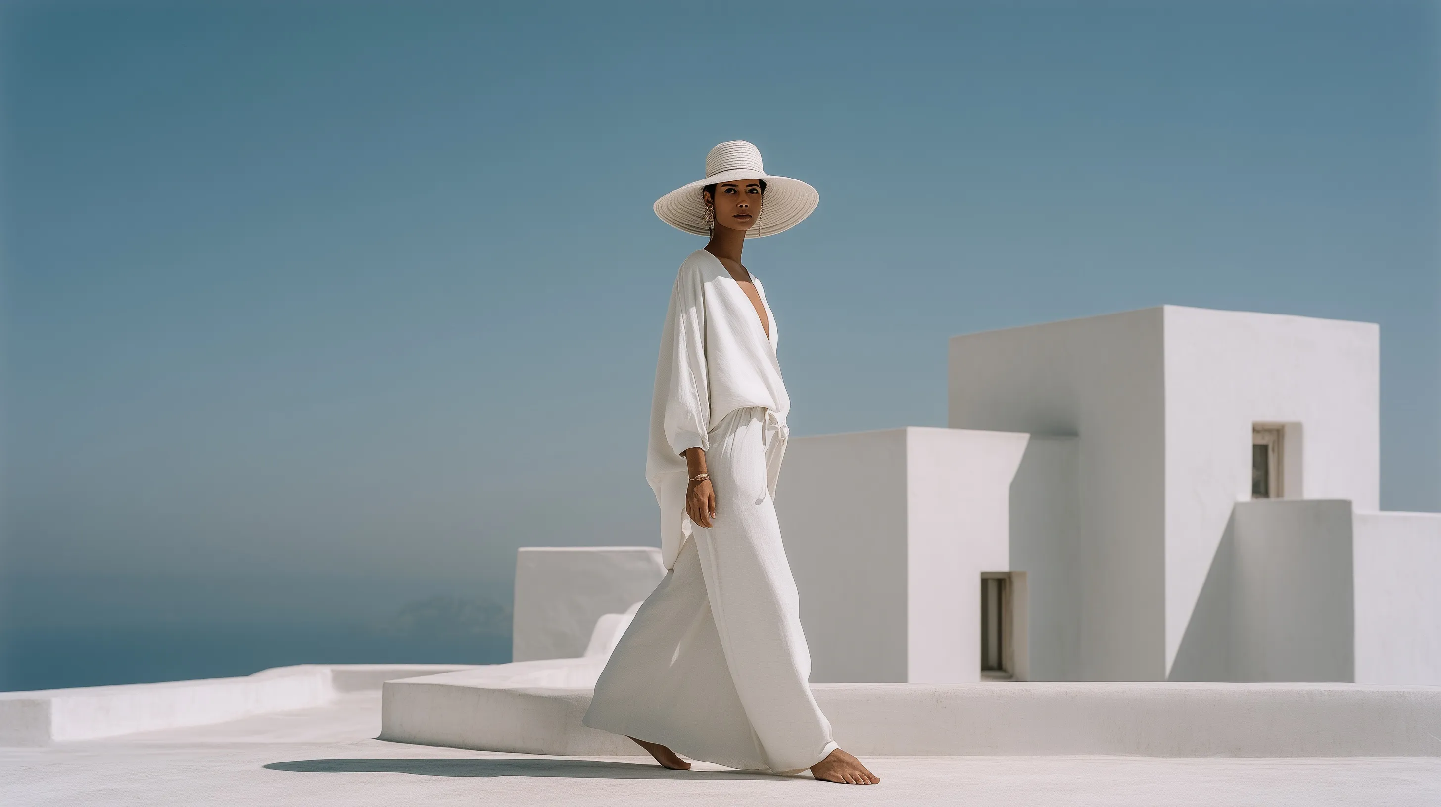 A vogue model in white summer outfit on a minimalist Santorini rooftop, editorial style photography.