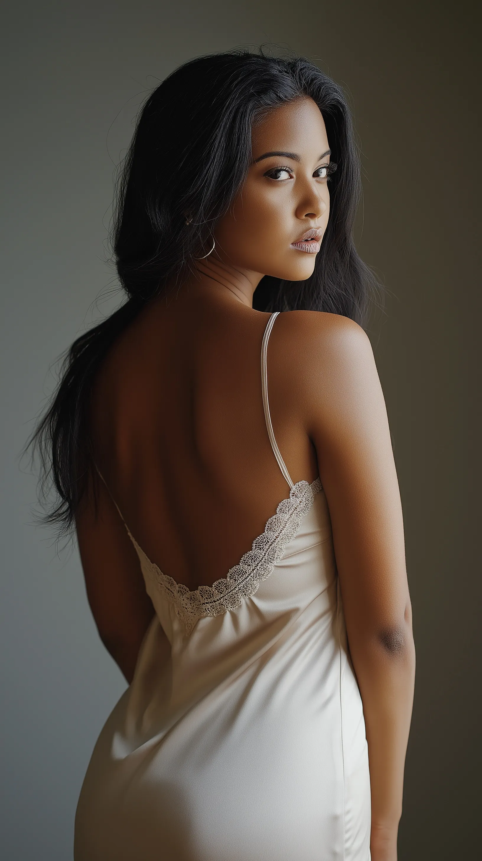 A short cream satin slip dress featuring delicate lace trim details against a neutral background.