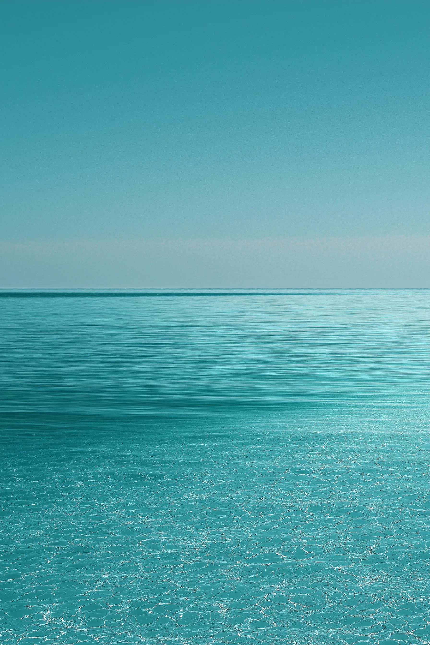 Minimalist summer wallpaper featuring a shimmering turquoise sea meeting a clear horizon under a bright sky.