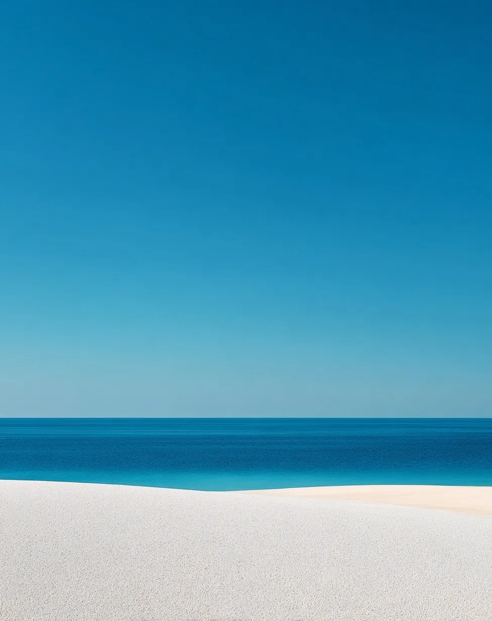 Minimalist white sand beach with clear blue sea and sky meeting at a distinct horizon line in 4k resolution.