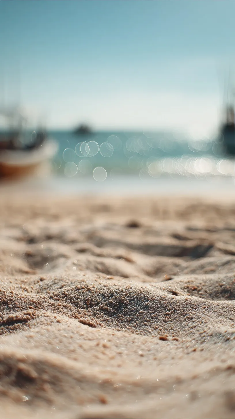Soft focus sandy beach with ocean waves and bokeh sunlight, coastal aesthetic background.