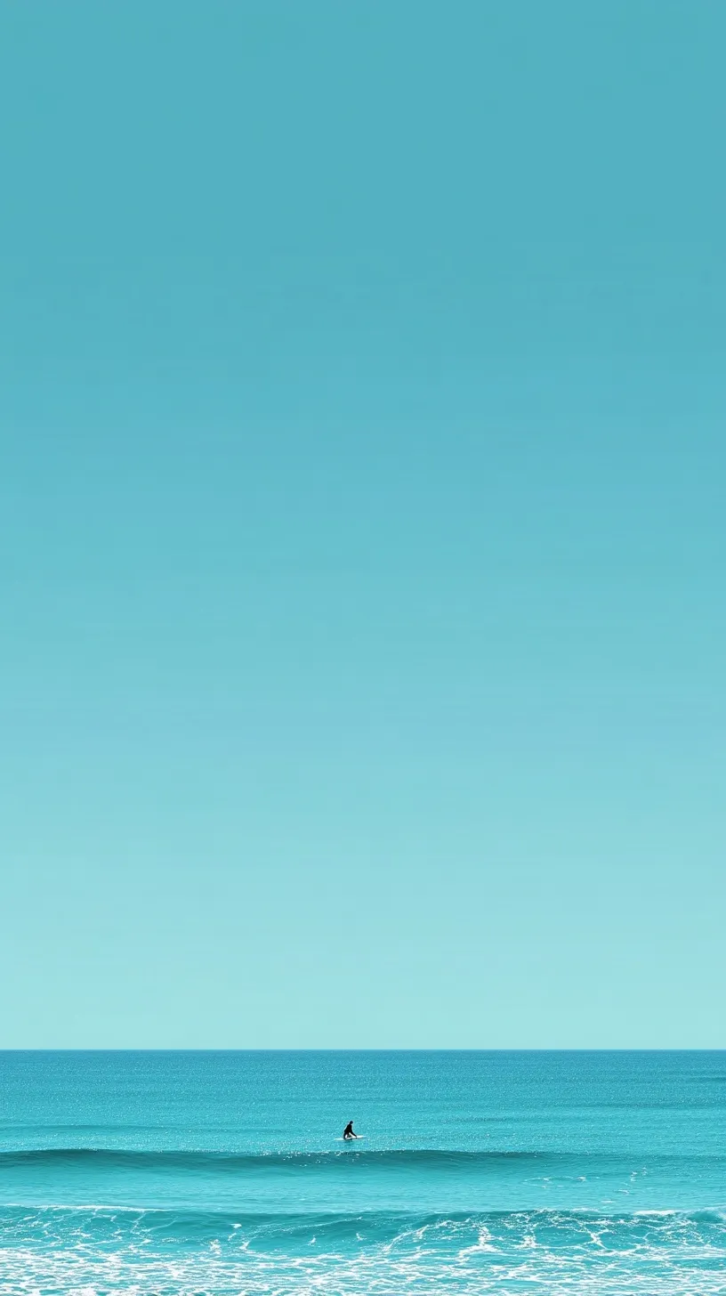 A lone surfer floating on calm turquoise sea water under a vast blue sky, realistic summer ocean wallpaper.