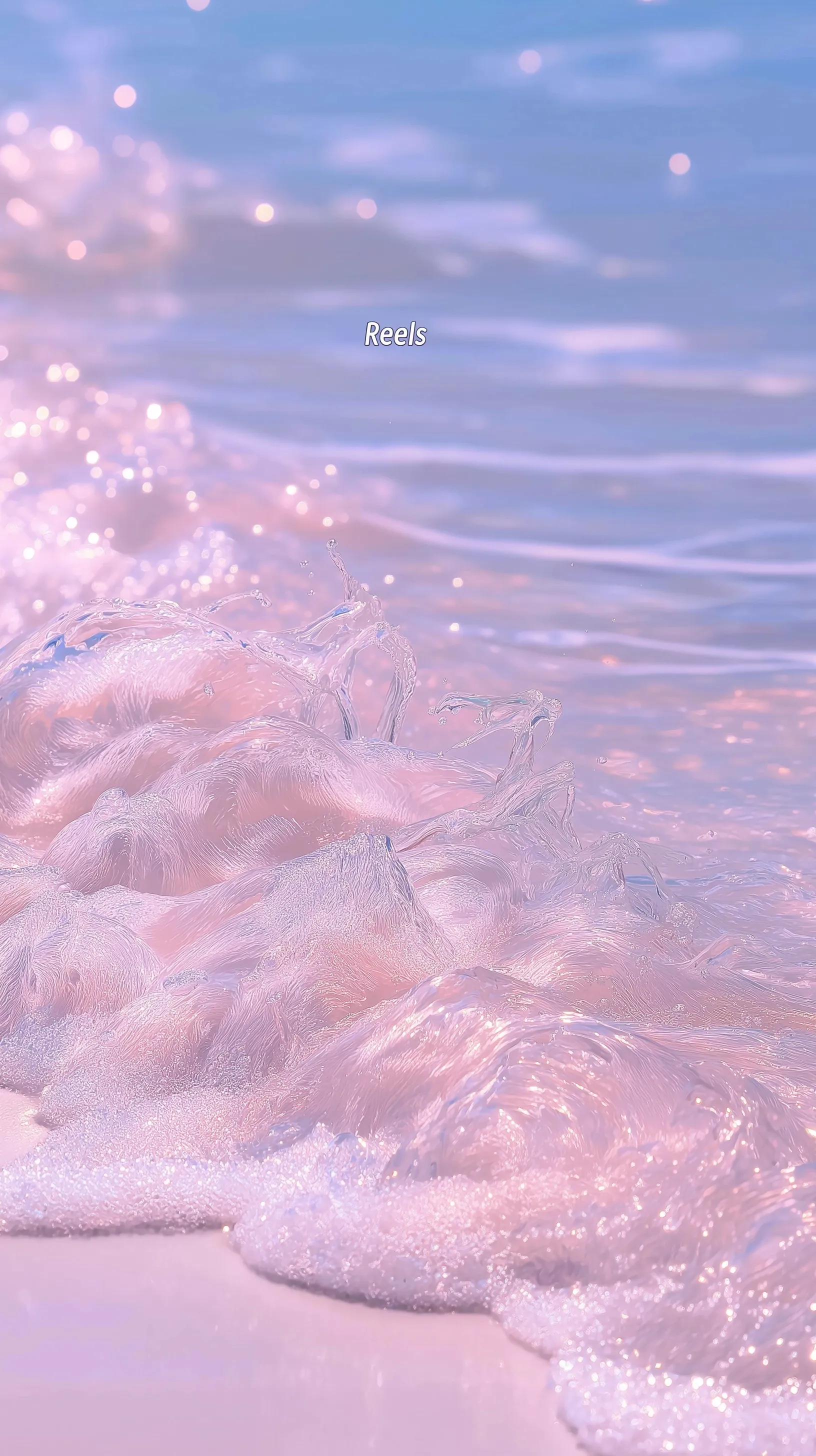 Aesthetic beach phone wallpaper featuring shimmering light pink water and the text Reels in white font.