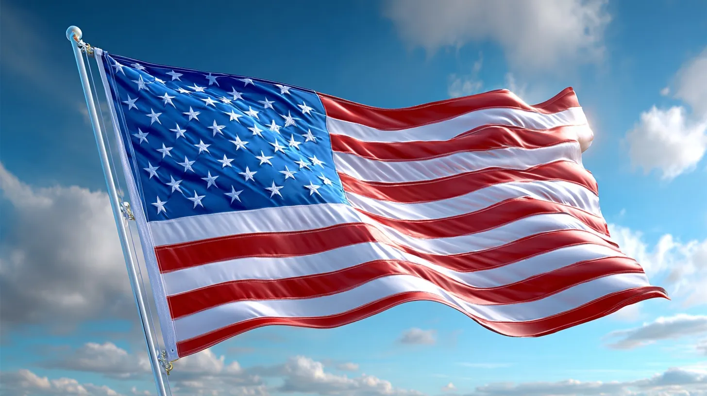 A realistic American flag waving against a clear blue sky with light clouds and copy space on the right.