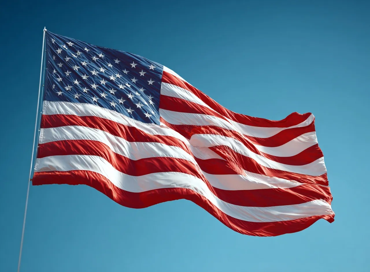 American flag waving against a clear blue sky, symbolizing freedom and national unity.