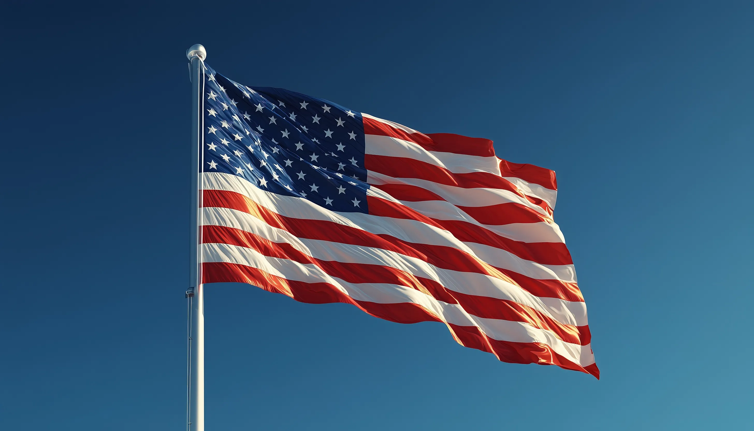 American flag waving on a white pole against a clear blue sky, centered with vivid colors and high resolution.