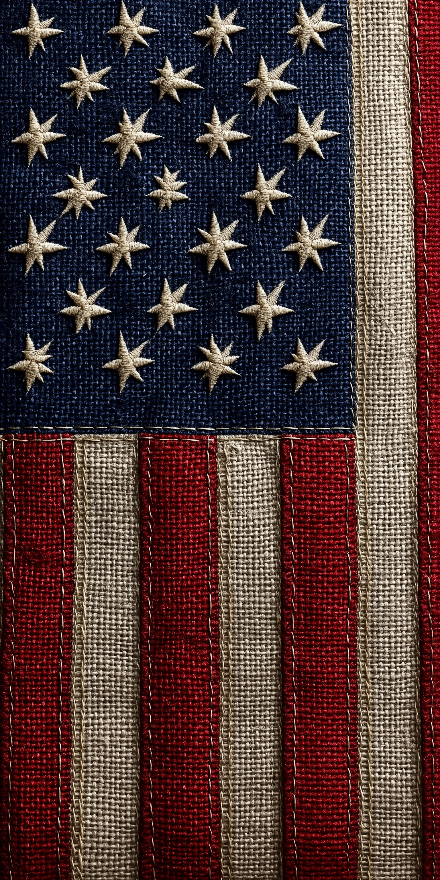 Close-up of a cotton American flag with visible stitching and textured fabric details.