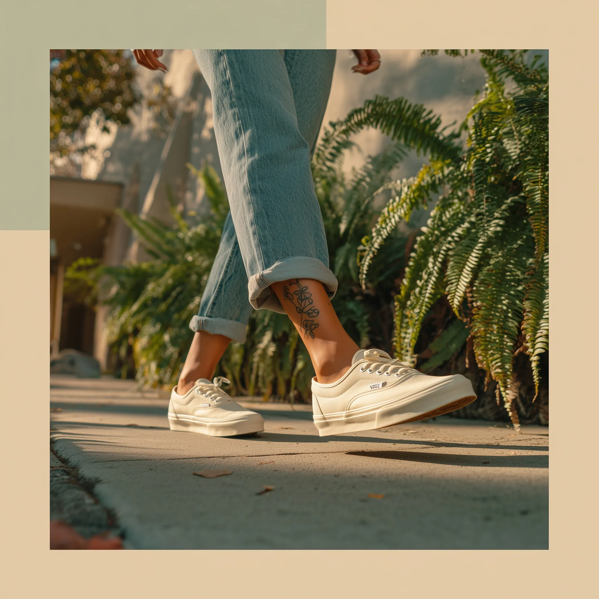 Cinematic side view of a woman in stonewash denim and white slip-on sneakers walking in a concrete urban setting.